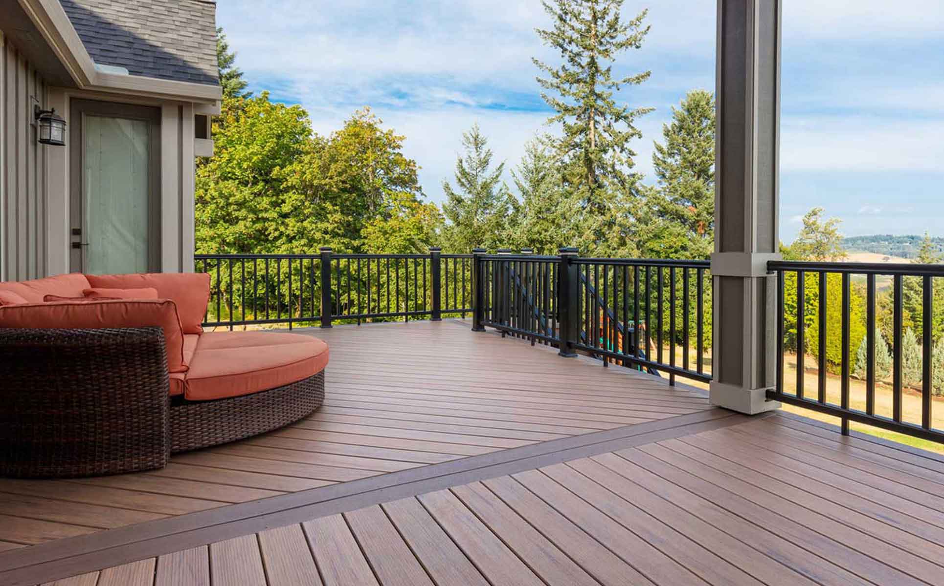 A custom residential deck built with composite deck boards. Additionally, this deck closely resembles those built by Deck and Door's deck builders in Minneapolis.